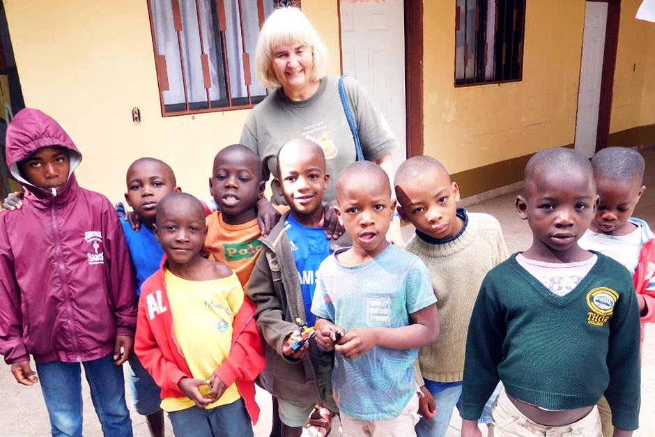 Elderly volunteer with group of children